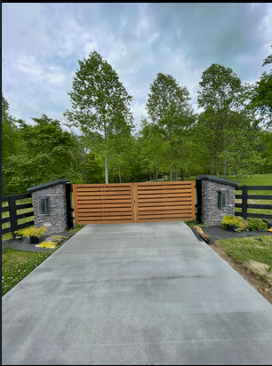 Horizontal slat wooden gate with stone accent columns