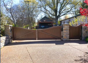 Brown stained wooden driveway gate with matching pedestrian gate